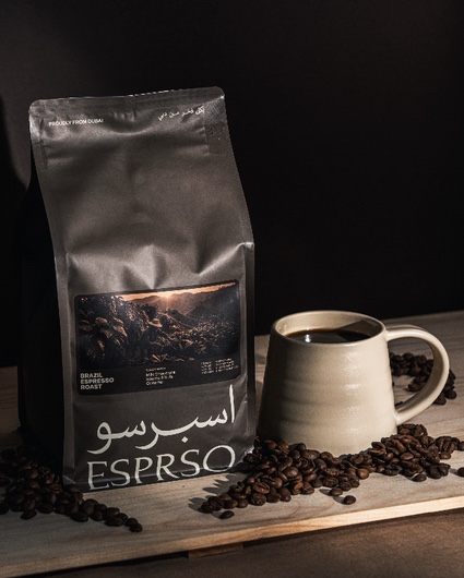 ESPRSO Brazil Espresso Roast bag beside a stoneware mug and scattered beans