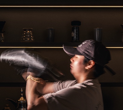 An ESPRSO barista shaking a cold brew behind the bar